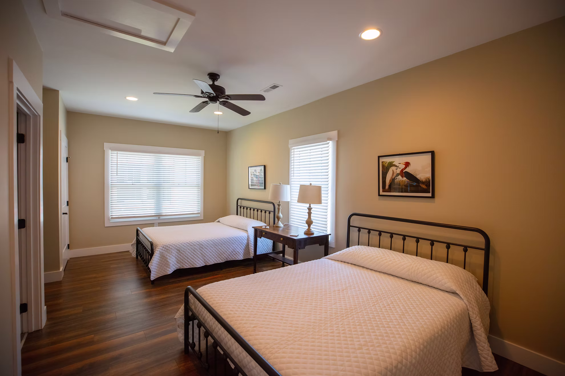 A cottage bedroom with two queen beds